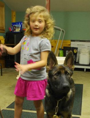 4 1/2-year-old Faith and 5-month-old German shepherd dog Aiko
